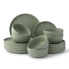 a stack of green dishes on a white background