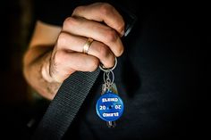 a person holding onto a lanyard keychain with the number 20 on it