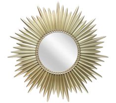 a gold sun mirror on a white wall with beaded trim around the edges and sides