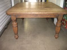 an old wooden table in a storage area