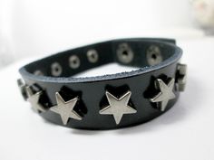 "Beautiful and trendy punk rock star bracelet with spikes rivet stars, great for men, women, boys or girls.  It features an adjustable flat leather bracelet with star charms on it and snap button clasp closure.  This bracelet is suitable for everyday wear.  Ideal birthday gift, perfect gift. Measurement: Bracelet approx. 7\" - 8\" in length (fits 6.5\" - 7.5\" wrist) wrist band approx.: 1/2\" in width   Material:   leather To view my other gift ideas, please visit my shop: https://www.etsy.com/shop/TrendHub Thank you for stopping by and happy shopping" Pet Memorial Necklace, Leather Wristbands, Leather Cuff Bracelet, Bracelet Leather, Wrist Band, Protection Necklace, Star Bracelet, Leather Cuffs Bracelet, Wrist Cuffs