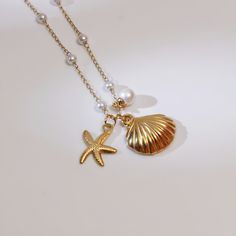 This exquisite seashell and starfish necklace is the perfect accessory for any beach lover. Crafted from 18K gold-plated stainless steel, this necklace offers both durability and elegance. The delicate chain is adorned with small pearls, enhancing its luxurious appeal. The necklace features a charming seashell pendant, measuring approximately 0.79" in height and 0.75" in width, paired with a starfish charm, creating a stunning ocean-inspired look. The adjustable chain length ranges from 16" to 2 Jewelry For Summer, Weddings Beach, Accessory Inspo, Seashell Pendants, Starfish Necklace, Beach Chic, Chic Jewelry, Ocean Inspiration, Chain Lengths