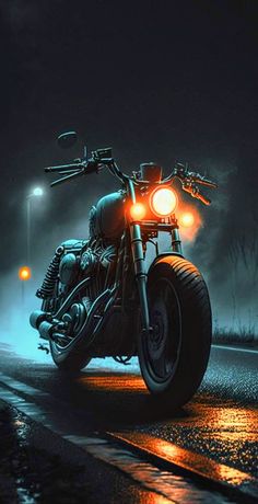 a motorcycle is parked on the side of the road at night with its lights on