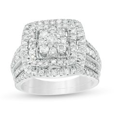 A dazzling look, this vintage-inspired diamond bridal set makes a romantic statement. Created in cool 10K white gold, the enchanting engagement ring features a cushion-shaped composite of diamonds - the largest a 1/10 ct. stone - wrapped in an intricate milgrain border. Diamonds sparkle along a flower-like frame and outer cushion-shaped halo while the triple-row shank glistens with diamonds and milgrain detailing. The perfect complement, a row of diamond adorns the coordinating wedding band. Rad Luxury White Bridal Sets With Center Stone, Dazzling White Gold Bridal Sets With Cubic Zirconia, Dazzling White Crystal Bridal Sets, Dazzling White Gold Crystal Bridal Sets, Diamond White Crystal Ring With Halo Design, Cubic Zirconia, White Gold Bridal Set, Diamond Frame, Peoples Jewellers, Cushion Diamond