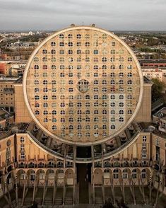 an aerial view of a large building with many windows on it's face and in the center