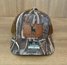 Whether they're seasoned hunters or eager newcomers, our elk hunting hat is the perfect accessory for every journey into the wilderness. It's more than just headwear; it's a symbol of dedication, the love for the hunt, and the thrill of pursuing one of the most majestic game animals. This hat make a statement at every celebration, bringing a touch of the outdoors to birthdays. The leather-like patch captures the essence of elk hunting adventures--mountains climbed, trails traversed, and the camaraderie that forms under the vast open sky. Give the gift of a hunting style, crafted for those who find solace in the quiet moments of nature and the adrenaline of a successful elk hunt. Our elk hunting hat is the perfect birthday surprise for the outdoorsmen who appreciate the beauty of the wilder Brown Hunting Cap, Brown Flat Bill Hunting Hat, Brown Flat Bill Hat For Hunting, Brown Hunting Hat With Leather Patch, Brown Leather Patch Hunting Hat, Brown Snapback Trucker Hat For Hunting, Brown Hunting Snapback Cap, Brown Snapback Hunting Cap, Brown Snapback Cap For Hunting