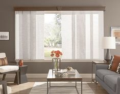 a living room filled with furniture and a window covered in white sheers on the windowsill