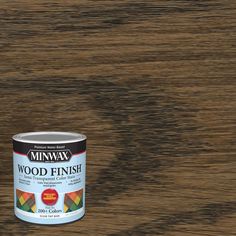 a can of wood finish sitting on top of a wooden table with the paint in it