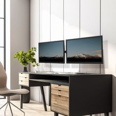 two computer monitors are sitting on top of a desk