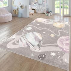 a child's bedroom with an area rug that looks like outer space