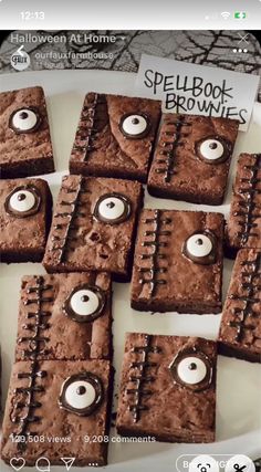 some brownies with eyeballs on them are sitting in a white plate and there is a sign that says spellbook brownies