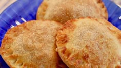 three fried pastries on a blue plate