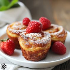 some raspberries are on a white plate with powdered sugar and muffins