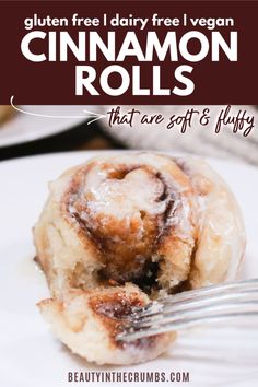 a cinnamon roll on a plate with a fork in it and the title reads gluten free dairy free vegan cinnamon rolls that are soft's fluffy