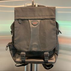 a gray bag sitting on top of a metal pole