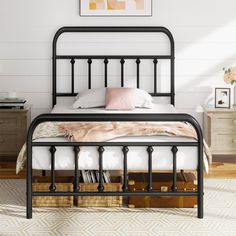 a black metal bed frame in a bedroom