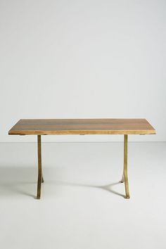 a wooden table sitting on top of a white floor