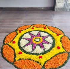 a colorful flower arrangement on the ground in front of a building