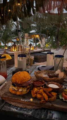 a table topped with lots of food on top of a wooden table covered in candles