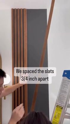 DIY Affordable Wood Slat Accent Wall || Cost Breakdown: Sanded Plywood - $25, Stain - $7 Slat Wall To Ceiling, Wood Slats On Walls, Wood Slat Front Porch, Wooden Slat Accent Wall Bedroom, Angled Slat Wall, Slat Wall Ceiling Ideas, Room Divider Slat Wall, Diy Vertical Wood Slat Wall, Vertical Slat Wall Interiors