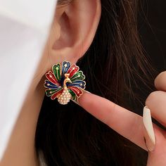 ✦ Looking to celebrate and throw a party? Our fantastic color peacock stud earrings are sure to make a statement. Peacocks symbolize mystery and pride, and these earrings capture that essence perfectly. When you adorn yourself with these peacock earrings, you become a captivating presence, catching everyone's attention in an instant. ----------- DESCRIPTIONS ----------- - SKU: WE120- Materials: Copper, 925 Sterling Silver, Enamel, Faux Pearl- Pendant Size(Length* Width): 2.5cm*2.5cm Gothic Minimalist, Color Peacock, Peacock Earrings, Elegant Gothic, Crystal Hoop Earrings, Nose Rings Hoop, Throw A Party, Classic Elegant, Peacocks