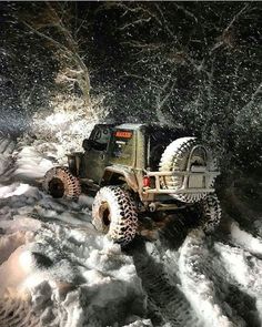 a jeep is driving through the snow with it's wheels up and tires down