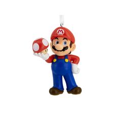 an ornament shaped like mario is holding a mushroom