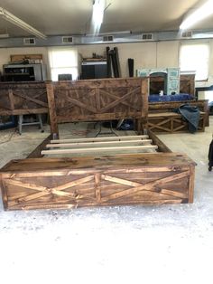 a bed frame made out of wood in a room