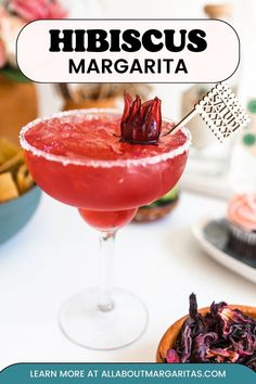 a close up of a drink in a glass on a table with other food items