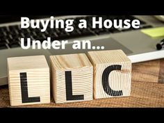 a wooden block that says buying a house under an lic