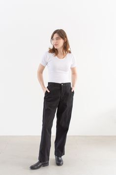 "These workwear cotton twill pants feature the following: zipper fly, high rise, belt loops, coin pocket, front pockets, back pockets with darts. Semi-Wide straight leg. These were originally white workwear chinos, now dyed black. Unisex Fit so the hips are more narrow than modern women's pants.  Material: 100% Cotton Twill  | Made in the USA in the 60s. Garment Dyed in Los Angeles in 2022. Condition: Great.    Measurements: 29\" Waist / 39\" Hips / 11.5\" Rise / 12.5\" Thigh / 8.25\" Leg Openin Workwear Chinos, Pant Trouser, Utility Pants, Fly High, Twill Pants, Piece Of Clothing, Modern Woman, Women's Pants, Cotton Twill