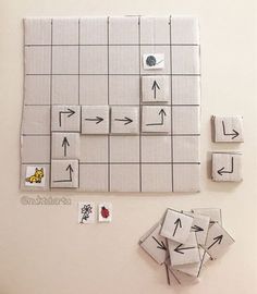 several pieces of paper are arranged on the wall to make a board game with arrows