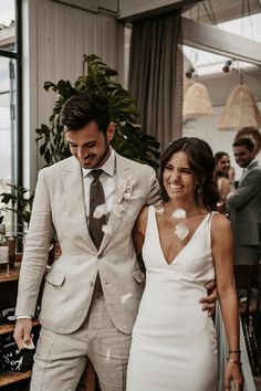 a bride and groom are walking through confetti as they exit their wedding ceremony