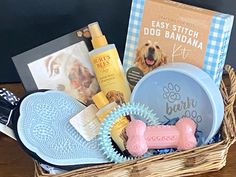 a basket filled with dog grooming supplies and books on top of a wooden table