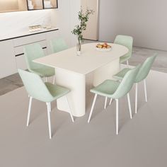 a white table with green chairs and a bowl of fruit on the dining room table