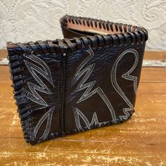 "I've taken a vintage black leather cowboy boot and turned it into a one of a kind wallet. Insert is genuine leather. Places for ID,credit cards, and cash. Hand stitched and crafted. Vintage and handmade items will not be perfect but I try to capture any flaws in photos. Would make a great gift for the cowboy or cowgirl in your life! Length open: 9 1/2\" Length folded: 5\" Width: 4\"" Vintage Black Trifold Wallet For Everyday Use, Vintage Black Wallet As A Gift, Vintage Black Rectangular Trifold Wallet, Black Leather Wallet Hand-stitched, Hand-stitched Black Leather Wallet, Vintage Hand-tooled Trifold Wallet, Hand-stitched Black Rectangular Wallet, Black Hand-stitched Rectangular Wallet, Black Rectangular Hand-stitched Wallets