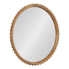 a round wooden mirror with beading around the edges and an oval frame, on a white background