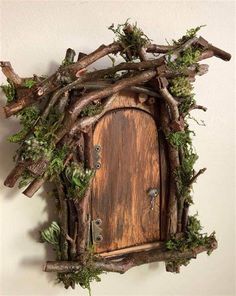 a wooden door surrounded by branches and moss