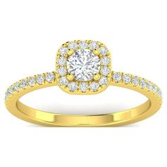 a yellow gold engagement ring with diamonds on the band and an oval halo setting in the center