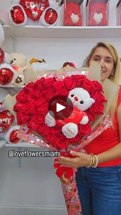 a woman holding a valentine's day heart wreath