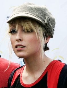 a woman with blonde hair wearing a hat