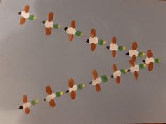 an art project made out of paper with ducks and carrots on the string attached to it