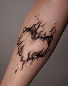 a black and white tattoo on the arm