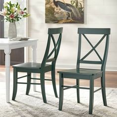 two green chairs sitting on top of a white rug