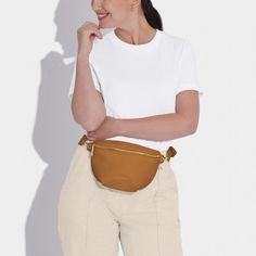 Our Maya Belt Bag in Black is here to accompany you on every summer adventure. With a captivating selection of six warm-weather ready colorways, this vegan leather gem effortlessly blends fashion with functionality. The adjustable wide strap guarantees a comfortable fit, while the internal pocket ensures effortless organization of small essentials. The gold-tone zip fastening not only adds a touch of elegance but also secures belongings, allowing for carefree dancing at festivals and beyond Versatile Belt Bag With Adjustable Strap For On-the-go, Brown Belt Bag With Detachable Strap For On-the-go, Brown Travel Belt Bag With Zipper, Casual Belt Bag For Summer On-the-go, Casual Faux Leather Shoulder Bag With Pockets, Beige Leather Belt Bag For On-the-go, Versatile Beige Belt Bag With Detachable Strap, Casual Cognac Leather Shoulder Bag, Trendy Leather Belt Bag With Zipper Closure