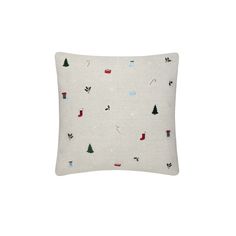 a white pillow with christmas trees on it