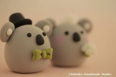 three toy bears with bow ties on each one's head are standing next to each other