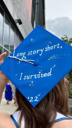 a blue graduation cap that says long story short, i survived 22