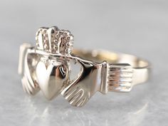 White gold is bright and brilliant in this vintage Claddagh ring. This would make a wonderful piece for every day, for anyone! Betrothal rings depicting two clasped hands date back many centuries in European history. The Irish version, the Claddagh ring, came about in the 1600s and has been produced continually since that time. Metal: 14K White Gold Width of Band: 11.0 mm Height off Finger: 2.0 mm Ring Size: 7.25 Marks: "14K" Stamped on the inside band Clasped Hands, Gold Claddagh Ring, Claddagh Ring, Claddagh Rings, Irish Jewelry, Irish Wedding, Cameo Ring, European History, Unisex Ring