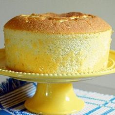 a cake sitting on top of a yellow plate next to a blue and white table cloth